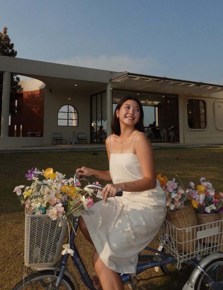 woman sitting on a bicycle decorated with flowers